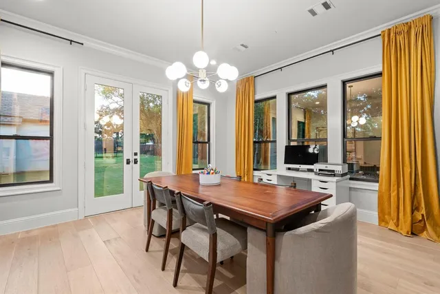 a view of a dining room with furniture and chandelier