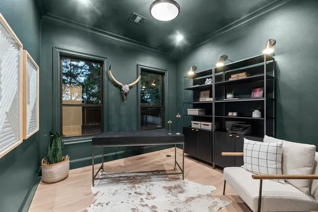 a dining room with furniture and a floor to ceiling window