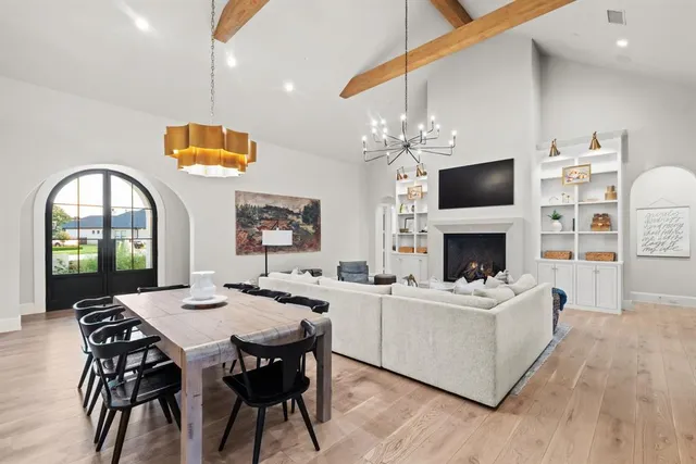 a view of a dining room with furniture a fireplace and wooden floor