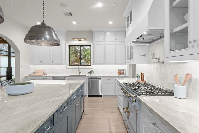 a kitchen with a sink stove and wooden cabinets
