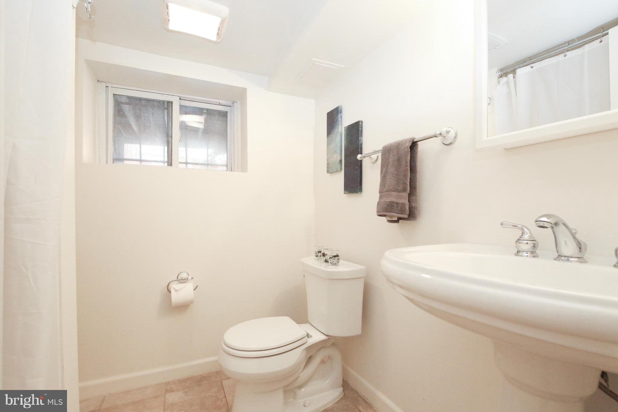 633 Columbia Road Northwest Washington, DC 20001 - Photo 22 of 30 a bathroom with a toilet sink and mirror