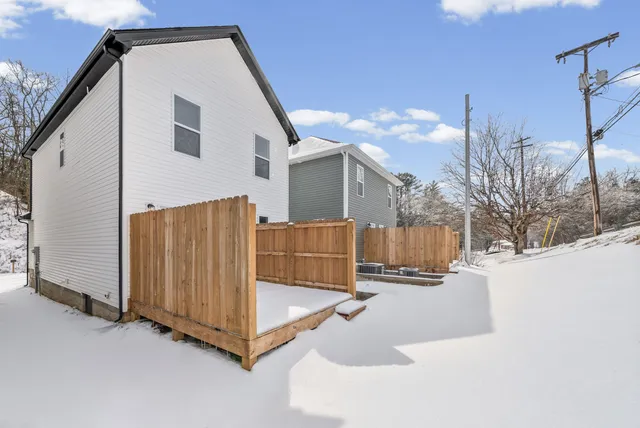 a view of a house with a snow in the yard