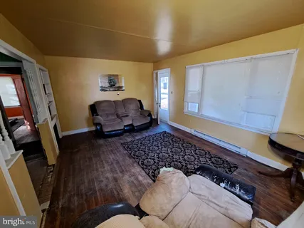 a room with refrigerator and mirror