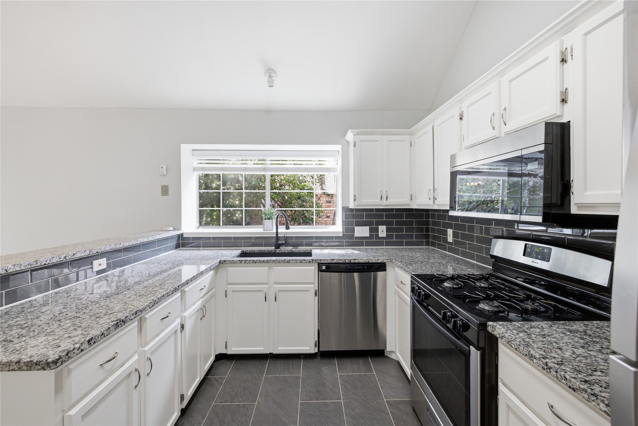 2922 Wickersham Lane Austin, TX 78741 - Photo 18 of 26 a kitchen with a sink stove top oven and refrigerator