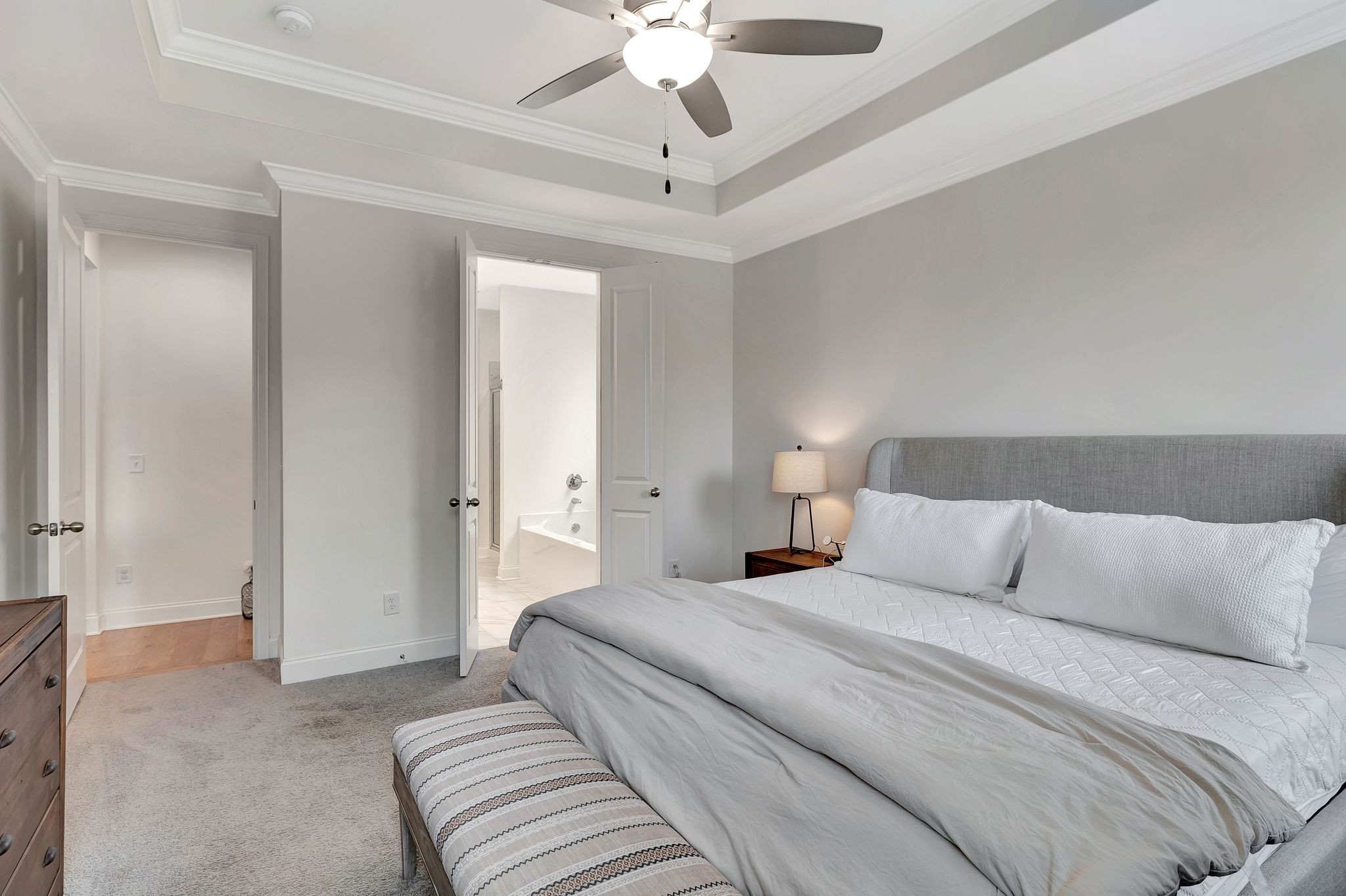3017 Shandor St Spring Hill Spring Hill, TN 37174 - Photo 22 of 46 a bedroom with a large bed and a chandelier