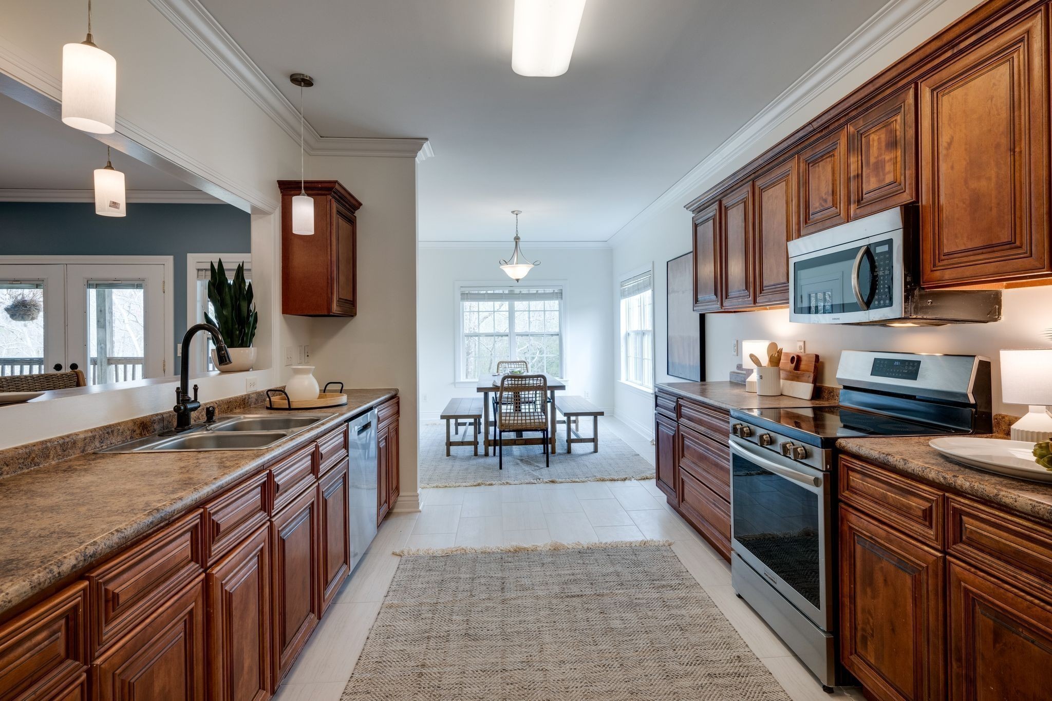 264 Fire Tower Road Dickson, TN 37055 - Photo 13 of 48 a kitchen with stainless steel appliances granite countertop a stove top oven a sink dishwasher a dining table and chairs with wooden floor