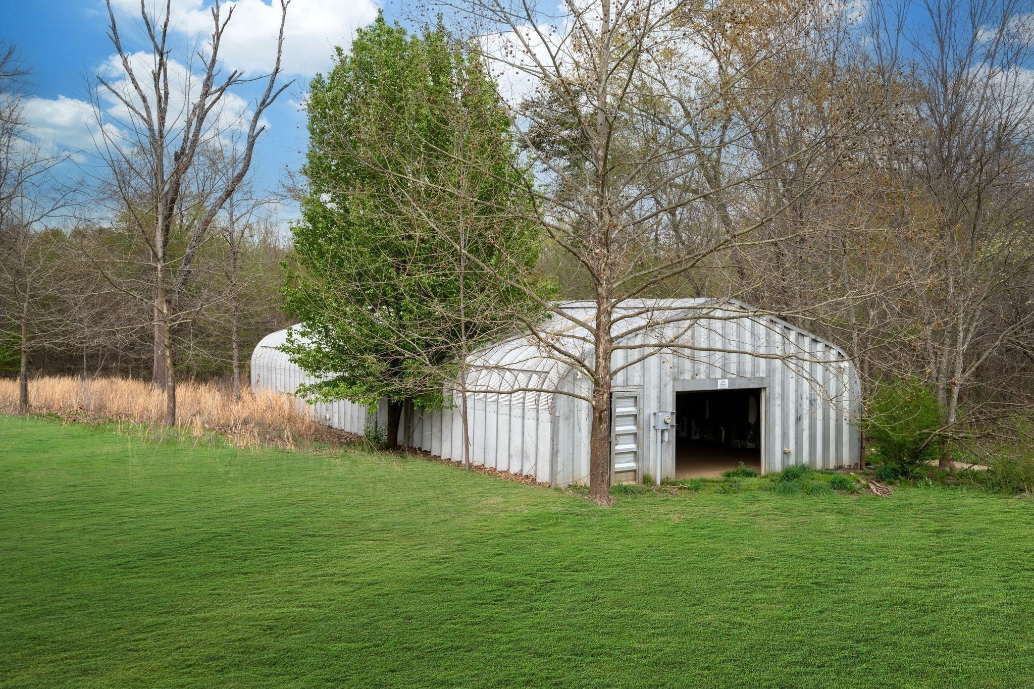 264 Fire Tower Road Dickson, TN 37055 - Photo 3 of 48 a view of white house with a big yard and large trees