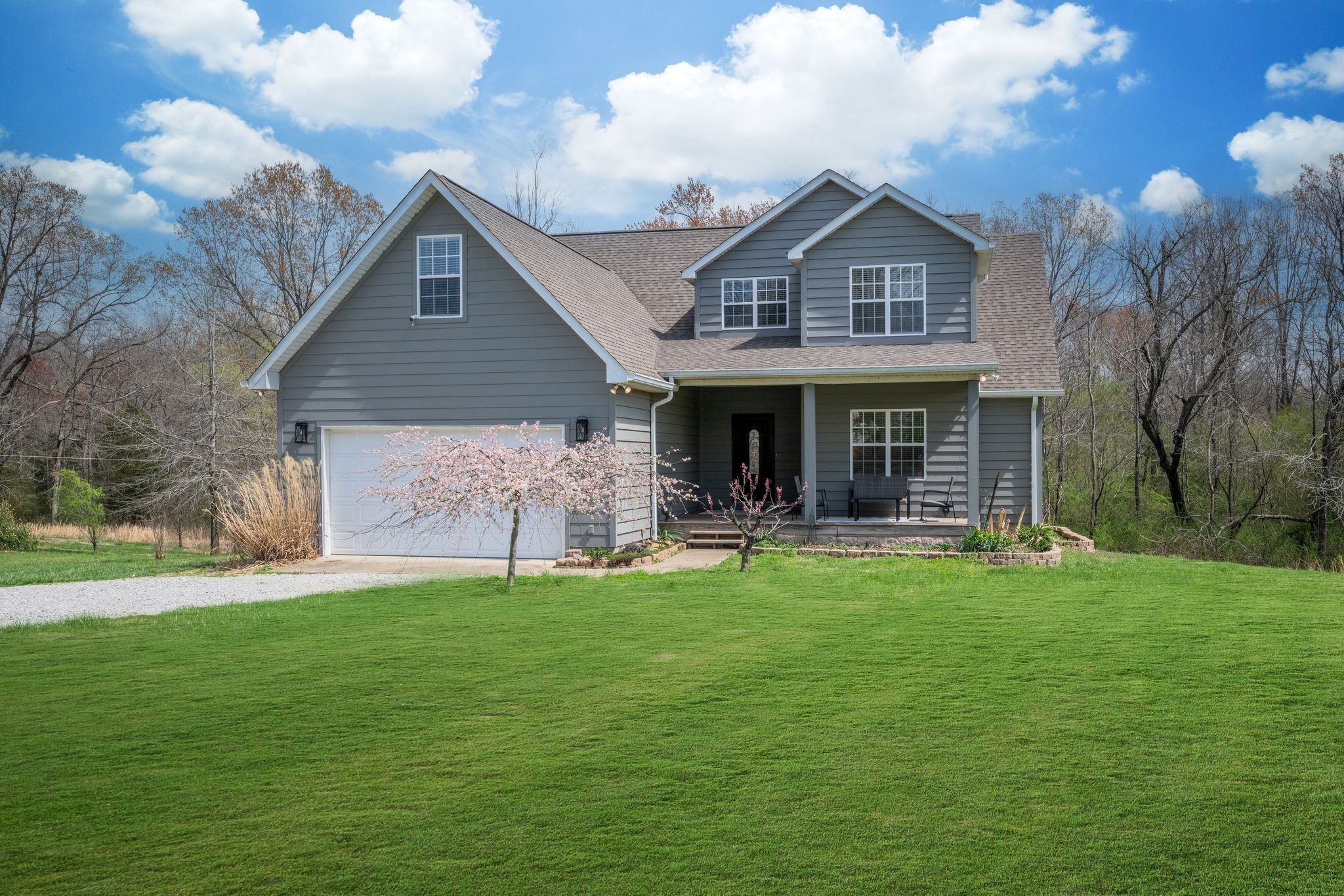 264 Fire Tower Road Dickson, TN 37055 - Photo 43 of 48 a front view of a house with a garden and porch