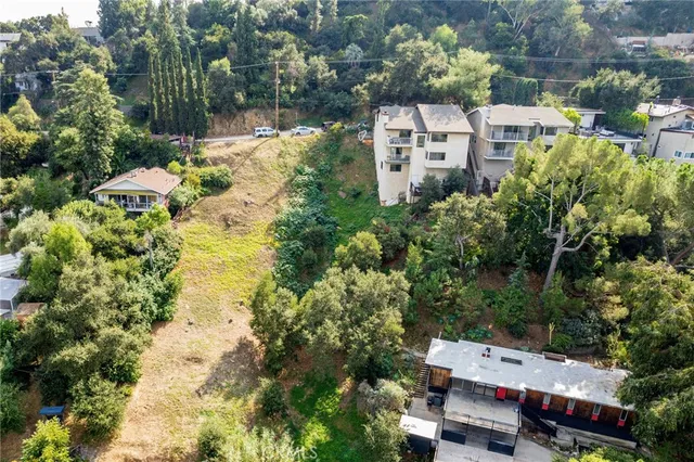 an aerial view of residential houses with outdoor space