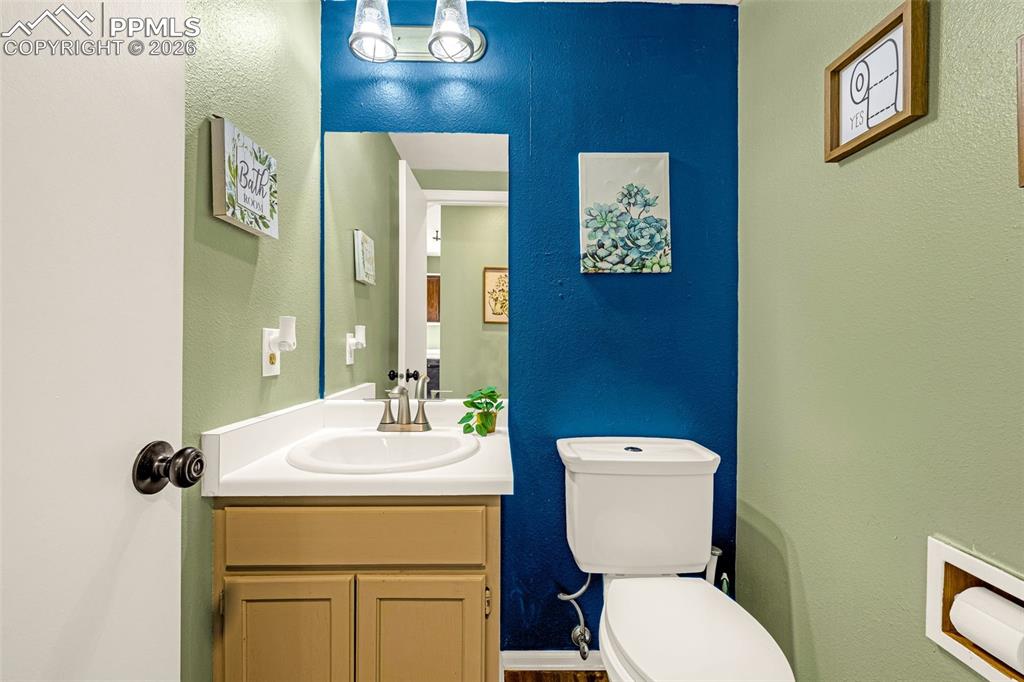 512 Harvest Moon Road Fountain, CO 80817 - Photo 11 of 41 a bathroom with a toilet sink and mirror