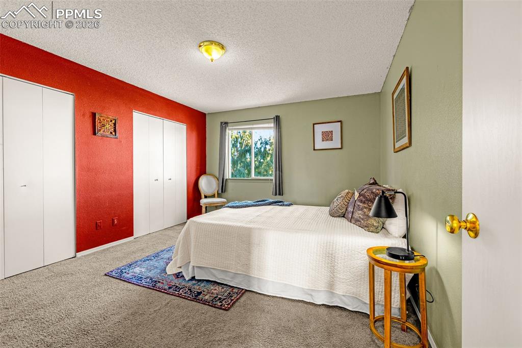 512 Harvest Moon Road Fountain, CO 80817 - Photo 13 of 41 a bedroom with a bed and wooden floor