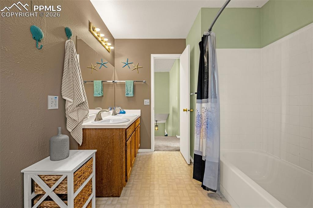 512 Harvest Moon Road Fountain, CO 80817 - Photo 16 of 41 a bathroom with a sink and mirror with bathtub