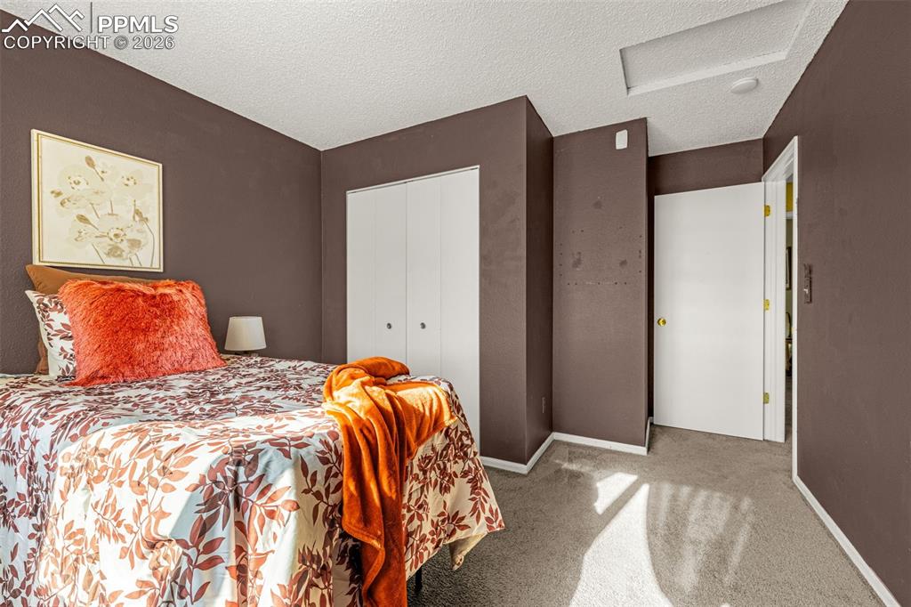 512 Harvest Moon Road Fountain, CO 80817 - Photo 19 of 41 a bedroom with a bed and a painting on the wall