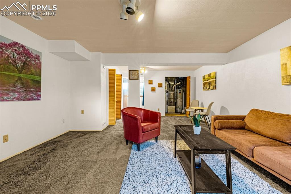 512 Harvest Moon Road Fountain, CO 80817 - Photo 22 of 41 a living room with furniture and a rug
