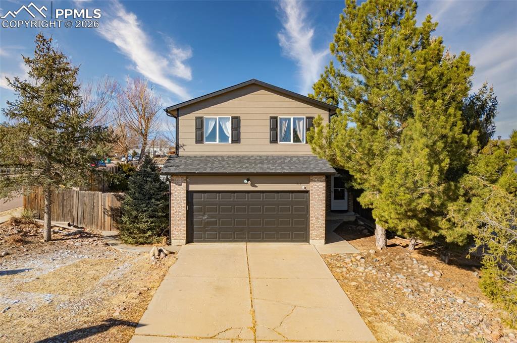 512 Harvest Moon Road Fountain, CO 80817 - Photo 41 of 41 a front view of a house with a yard and garage