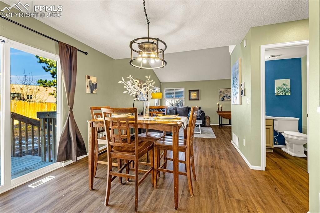 512 Harvest Moon Road Fountain, CO 80817 - Photo 8 of 41 a view of a dining room with furniture wooden floor and chandelier