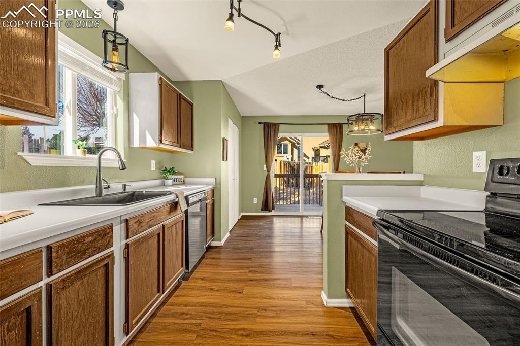 512 Harvest Moon Road Fountain, CO 80817 - Photo 10 of 41 a kitchen with stainless steel appliances a sink stove and cabinets