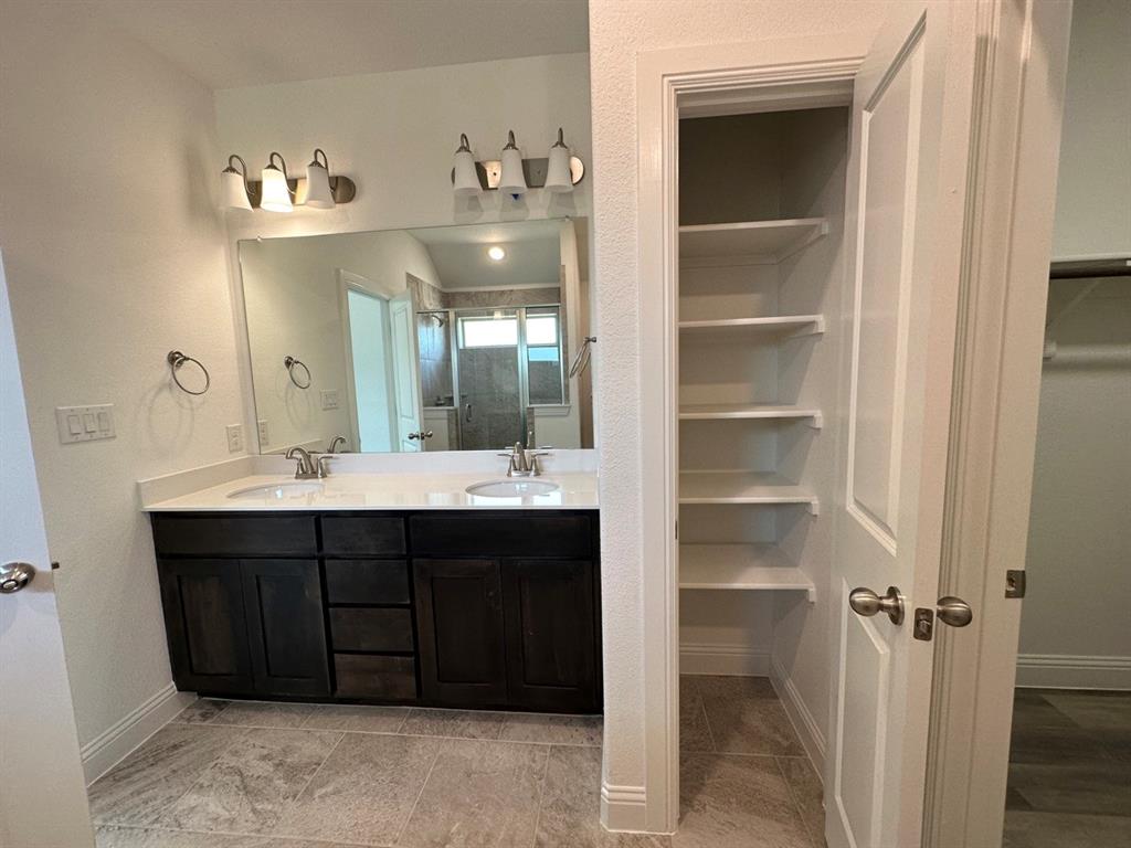 418 South 2nd Street Krum, TX 76249 - Photo 15 of 17 a bathroom with a sink vanity and a mirror