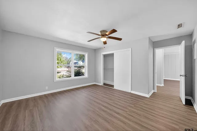 wooden floor in an empty room with a window