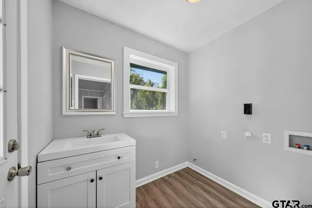 a bathroom with a sink and a window