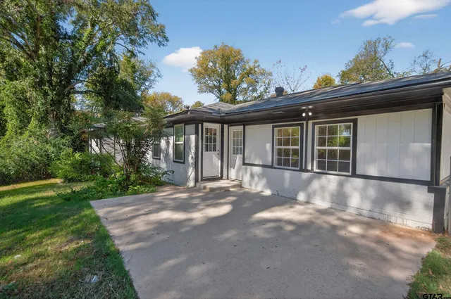 a view of a house with a window and wooden fence