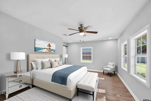 a bedroom with a bed and wooden floor