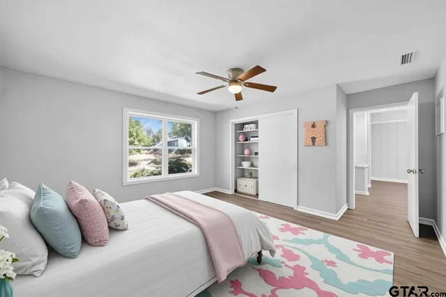 a bedroom with a large bed and a window