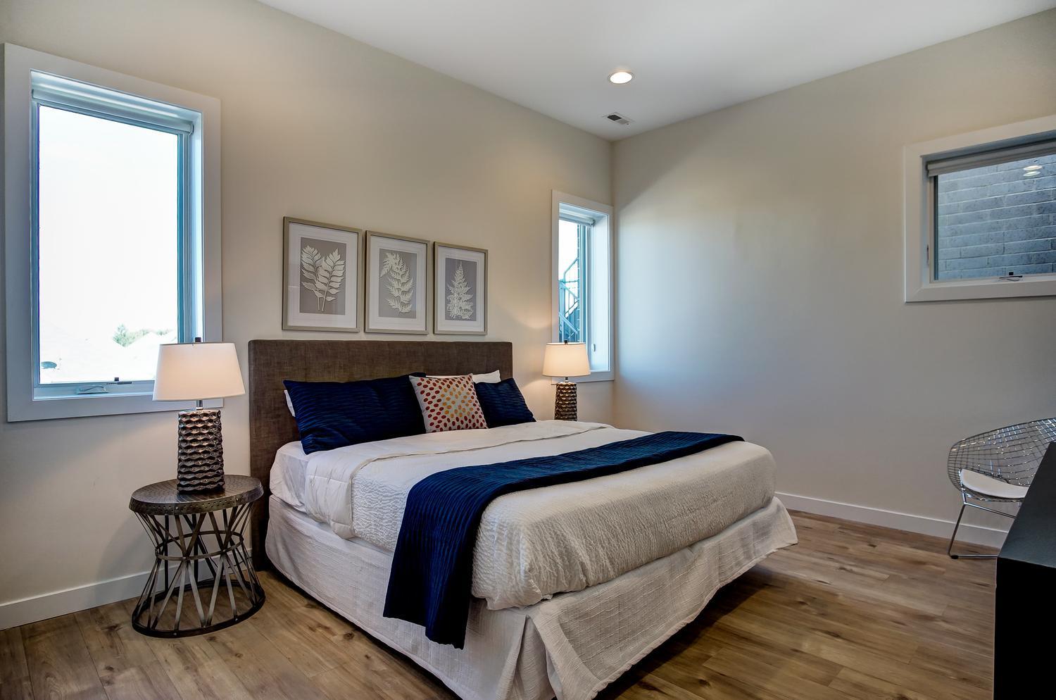 2532 West Addison Street, Unit 3E Chicago, IL 60618 - Photo 13 of 20 a bedroom with a bed and wooden floor