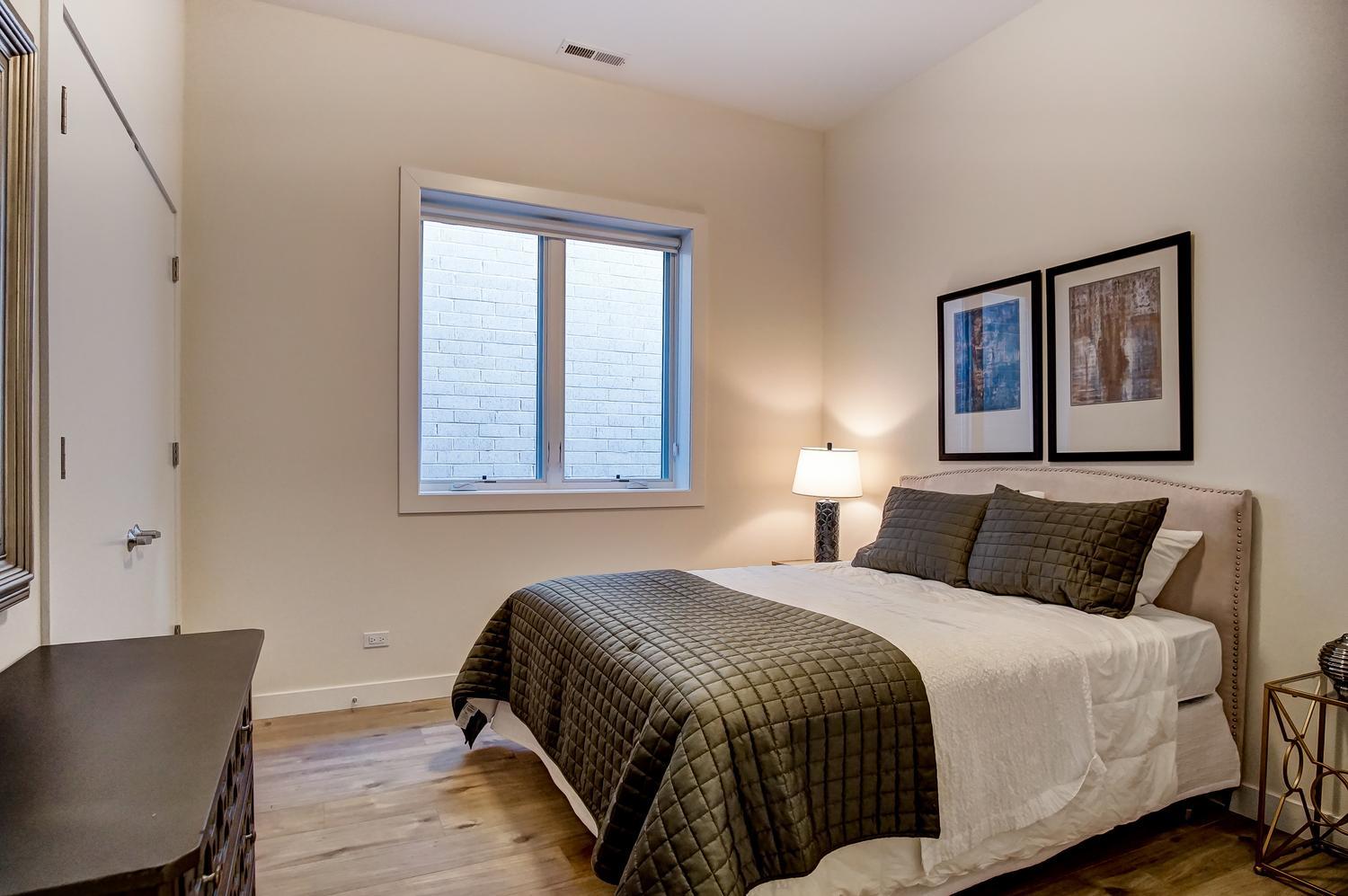 2532 West Addison Street, Unit 3E Chicago, IL 60618 - Photo 17 of 20 a bedroom with a bed and window