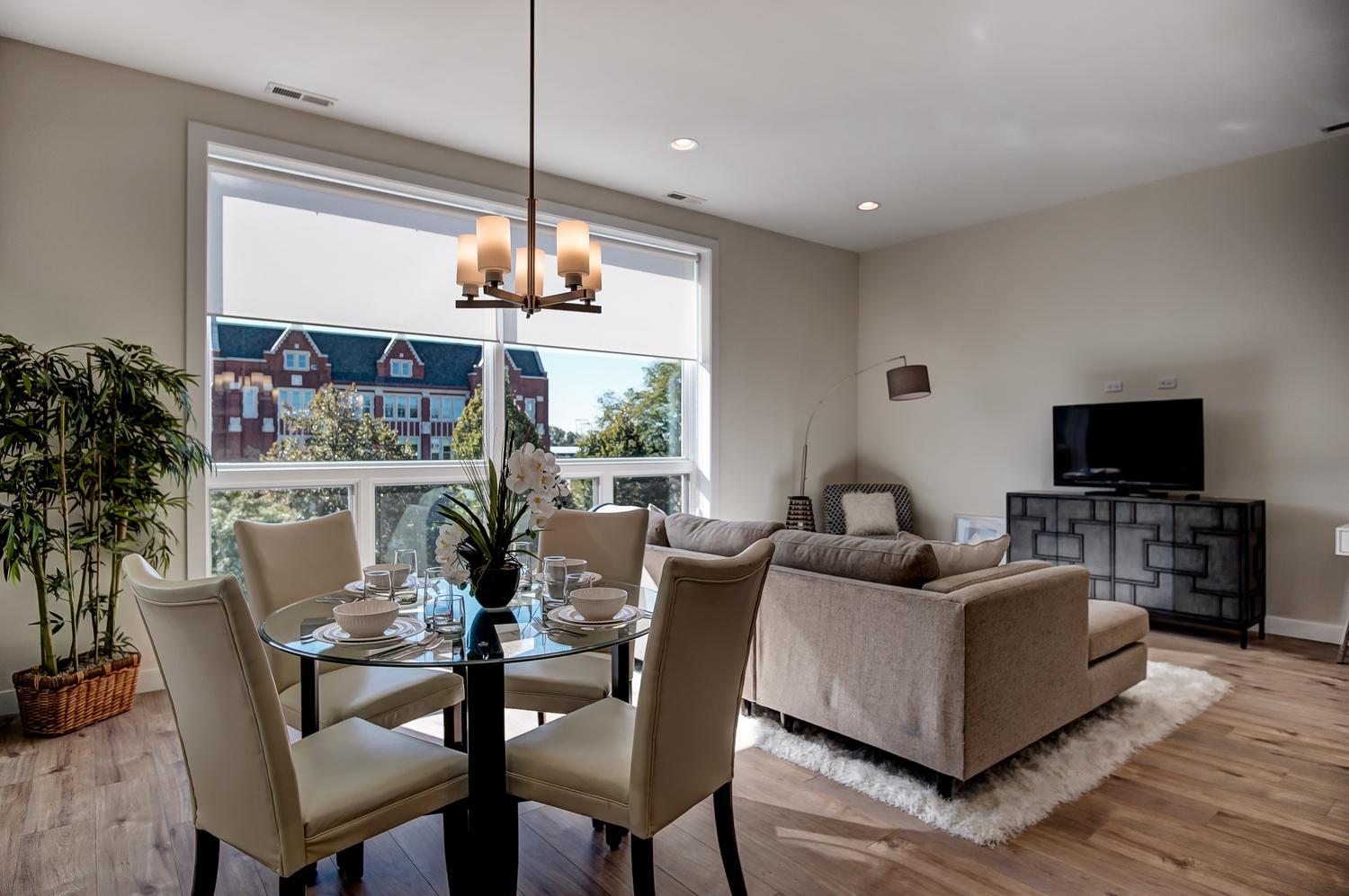 2532 West Addison Street, Unit 3E Chicago, IL 60618 - Photo 5 of 20 a view of a dining room with furniture window and wooden floor