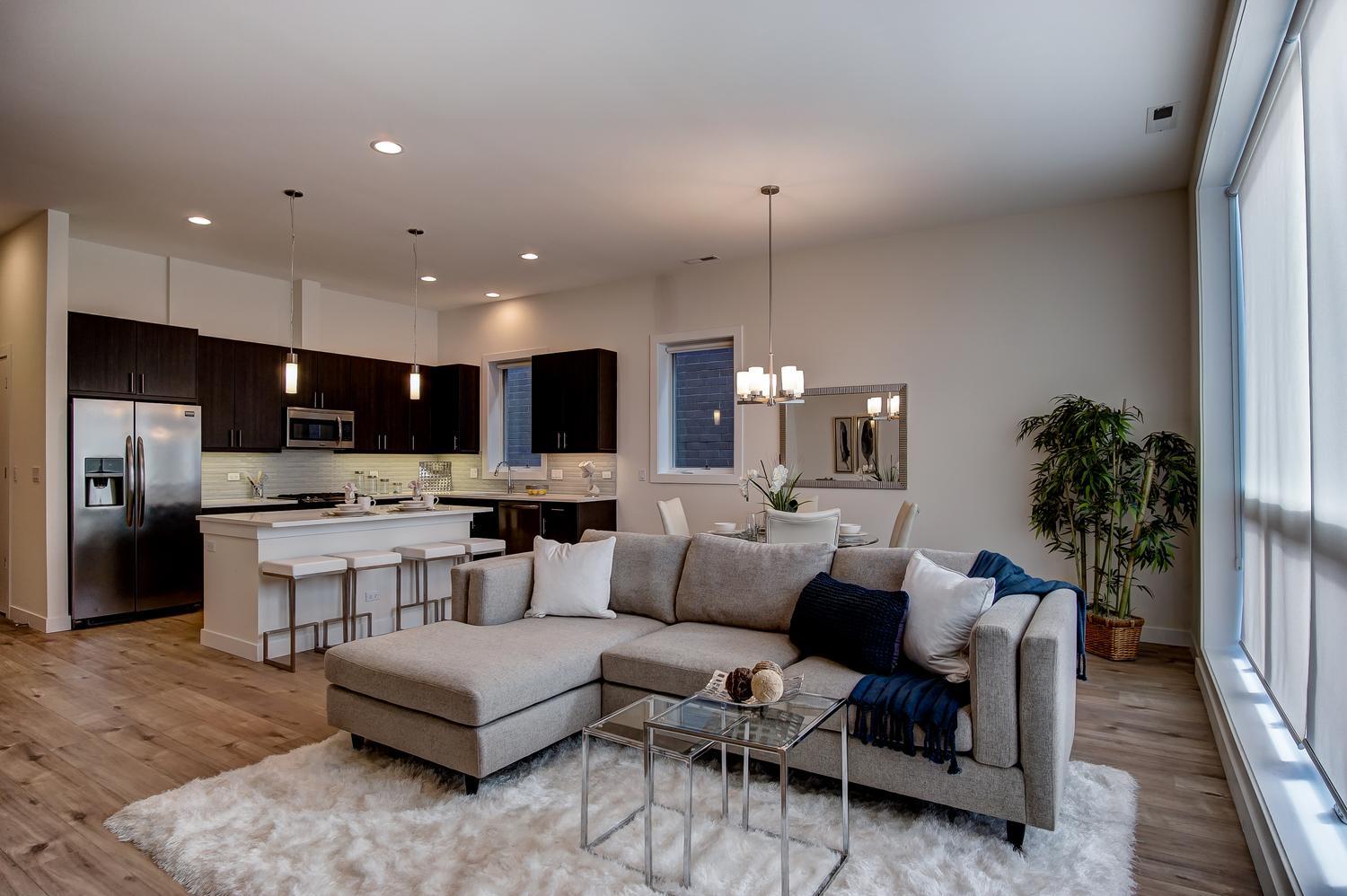 2532 West Addison Street, Unit 3E Chicago, IL 60618 - Photo 6 of 20 a living room with lots of furniture and kitchen view