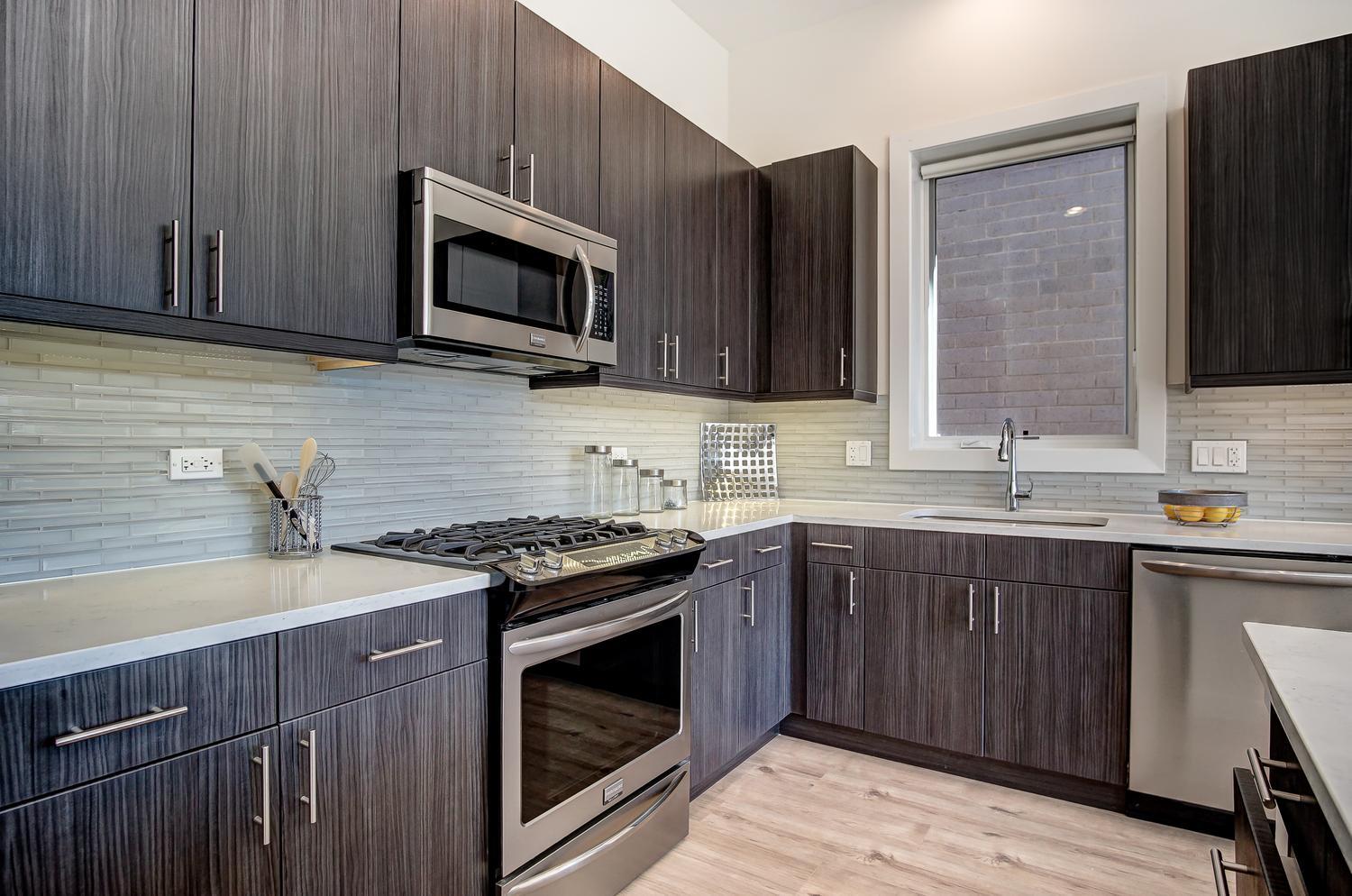 2532 West Addison Street, Unit 3E Chicago, IL 60618 - Photo 8 of 20 a kitchen with stainless steel appliances a stove microwave and sink