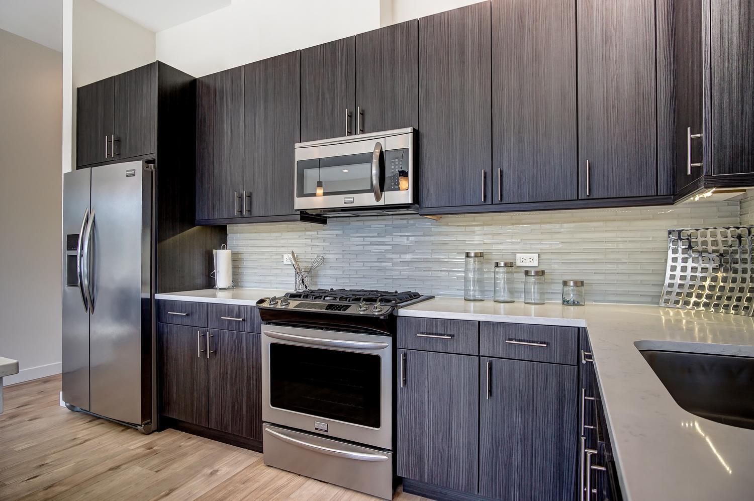 2532 West Addison Street, Unit 3E Chicago, IL 60618 - Photo 9 of 20 a kitchen with stainless steel appliances a stove a sink a refrigerator and cabinets