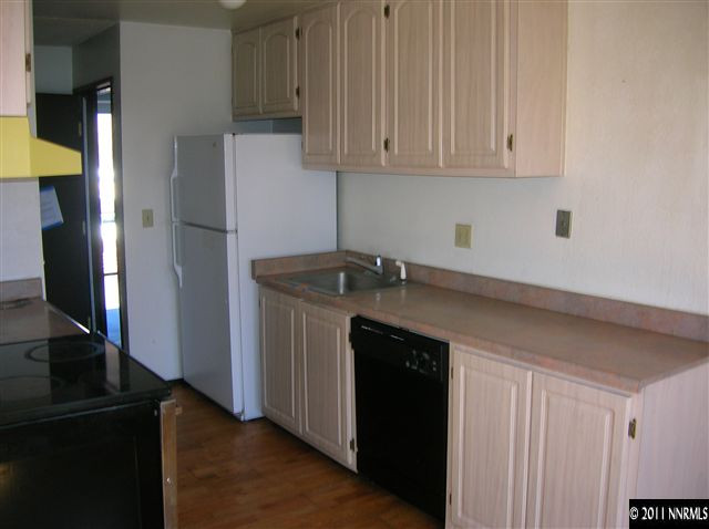 4602 Neil Road, Unit 90 Reno, NV 89502 - Photo 4 of 10 a kitchen with a sink and a refrigerator