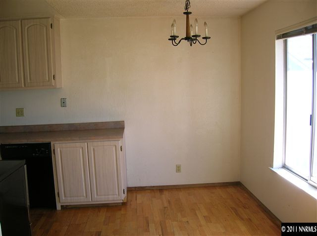 4602 Neil Road, Unit 90 Reno, NV 89502 - Photo 5 of 10 a view of a kitchen with wooden floor and white walls