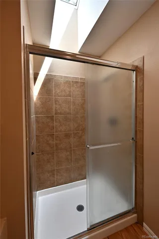 a bathroom with a glass shower door