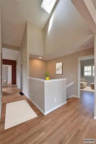 a view of a livingroom with wooden floor and furniture