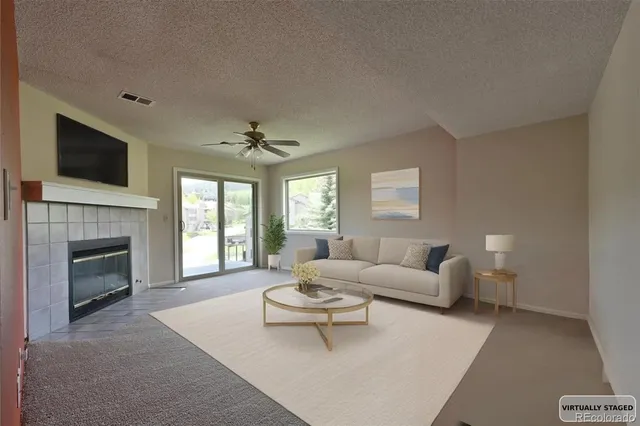 a living room with furniture a fireplace and a flat screen tv