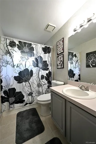 a bathroom with a sink toilet and mirror