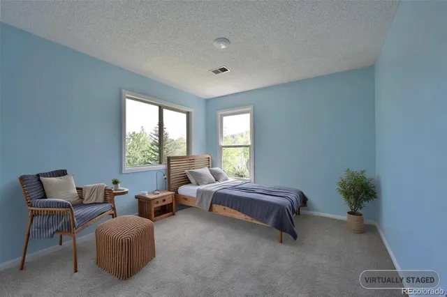 a spacious bedroom with a bed and a couch