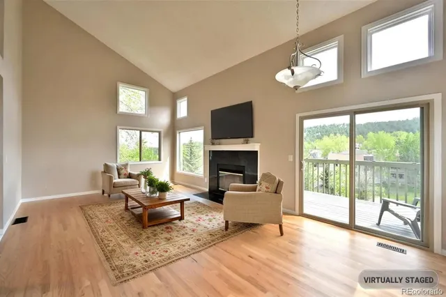 a living room with furniture a fireplace and a flat screen tv