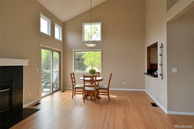 a dining room with furniture and wooden floor