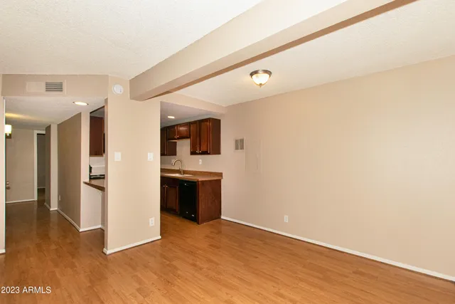 a view of a kitchen with a sink and a refrigerator