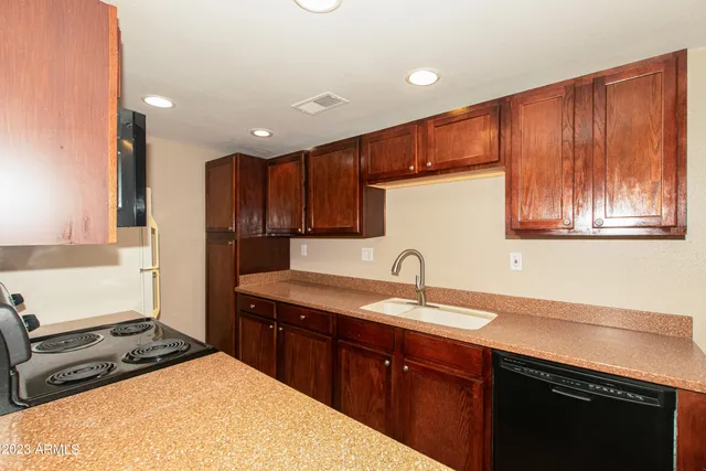 a kitchen with a sink stove and cabinets