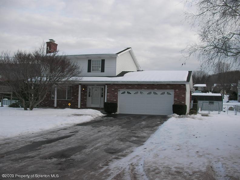 1195 Chase Road Shavertown, PA 18708 - Photo 1 of 10 a front view of a house with yard and garage