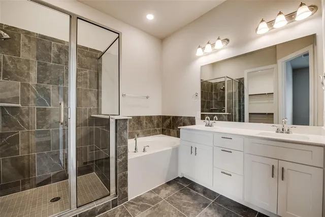 a bathroom with a sink and a mirror with bathtub