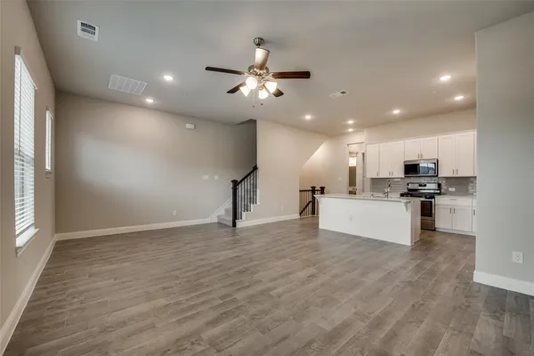 a view of kitchen with sink and wooden floor