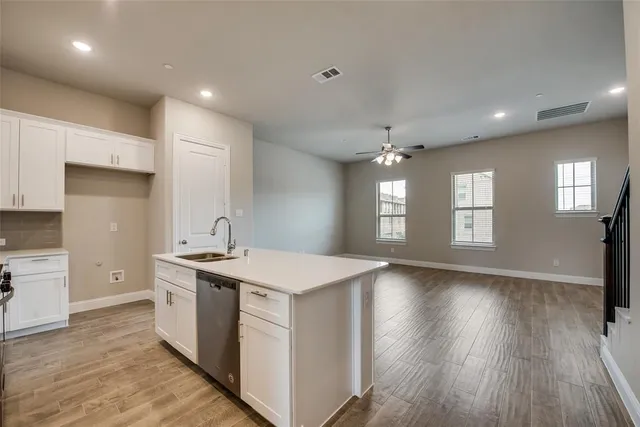 a kitchen with a stove a sink and a refrigerator