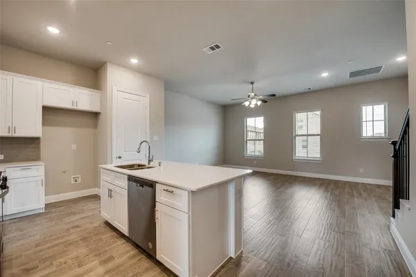 a kitchen with a stove a sink and a refrigerator