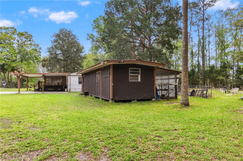 3650 176 Place Inglis, FL 34449 - Photo 37 of 49 a view of a backyard with a garden
